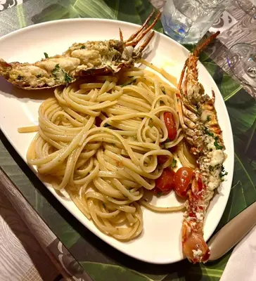 a plate of pasta and shrimp on a table at Villa KAMBUSA appartamento SOFIA in Las Galeras
