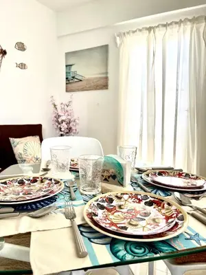 a dining room table with plates of food on it at Apartamento a solo pasos del centro y la playa in Bayahibe