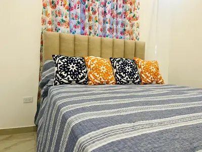 a bed with pillows on it in a bedroom at The Beauty and The Beach in Nagua