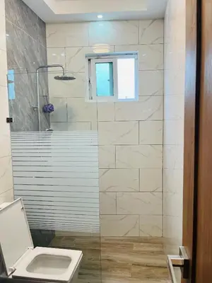 a bathroom with a toilet and a glass shower at The Beauty and The Beach in Nagua