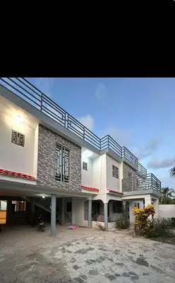 a large white building with a balcony on it at Apartamento Oasis in La Caleta