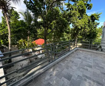 a person with a red umbrella on a fence at Apartamento Oasis in La Caleta