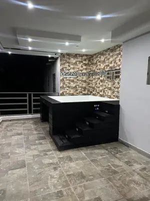 a large room with a black counter and a wall at Apartamento Oasis in La Caleta