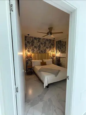 a bedroom with a bed and a ceiling fan at Escapada Cana Rock con Piscina y Club de Playa in Punta Cana