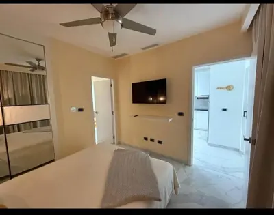 a bedroom with a bed and a ceiling fan at Escapada Cana Rock con Piscina y Club de Playa in Punta Cana