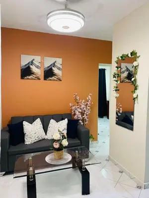 a living room with a couch and a table at De pina apartaestudio in Santiago de los Caballeros