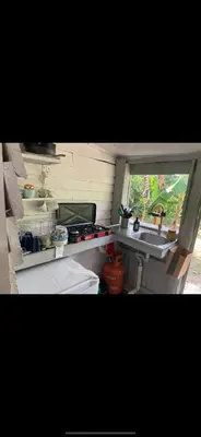 a kitchen with a sink and a window in a trailer at La paz y tranquilidad