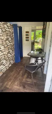 a patio with a table and a bench on a porch at La paz y tranquilidad