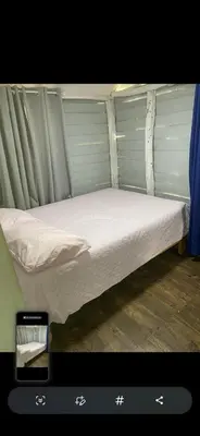 a small bed in a room with at La paz y tranquilidad