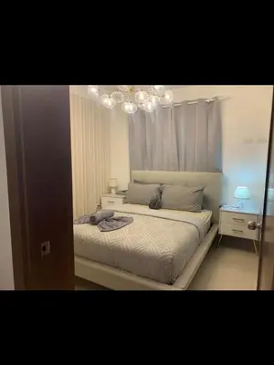 a bedroom with a bed and a chandelier at Leni's Confort in Santiago de los Caballeros