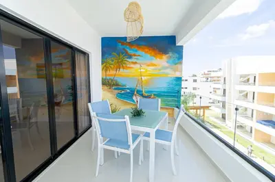 a dining room with a painting of the beach at Tranquil 2BR Retreat in Sunshine Bayahibe in San Rafael del Yuma