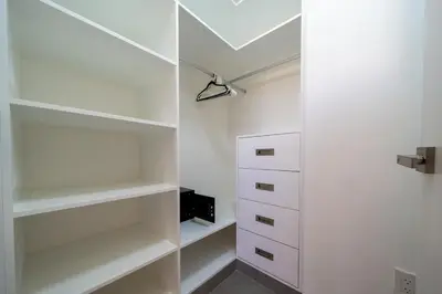 a white walk in closet with white shelves at Location , Vibe , Style in Sosúa