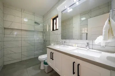 a bathroom with a sink and a toilet and a mirror at Location , Vibe , Style in Sosúa