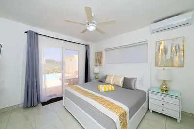 a bedroom with a bed and a ceiling fan at Luxury Villa, Garden View and Private Pool in La Mulata