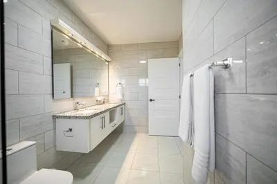 a white bathroom with a sink and a toilet at Luxury Villa, Garden View and Private Pool in La Mulata