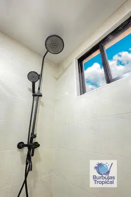 a shower with a shower head in a bathroom at 3 Bdr Apt in La Romana - Full Kitchen - Pool - Gym - Security in Cumayasa Kilómetros Diez