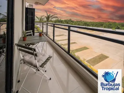 a view from a balcony with a chair and a painting at 3 Bdr Apt in La Romana - Full Kitchen - Pool - Gym - Security in Cumayasa Kilómetros Diez
