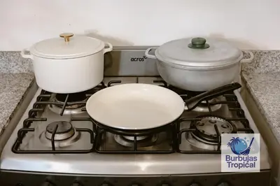 a stove top with a pot and a pan on it at 3 Bdr Apt in La Romana - Full Kitchen - Pool - Gym - Security in Cumayasa Kilómetros Diez