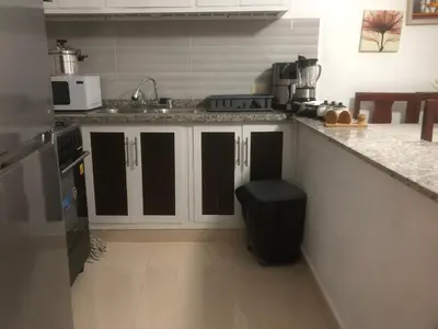 a kitchen with a counter with a trash can in it at Apartamento de lujo amueblado Guadeca B in Juan López