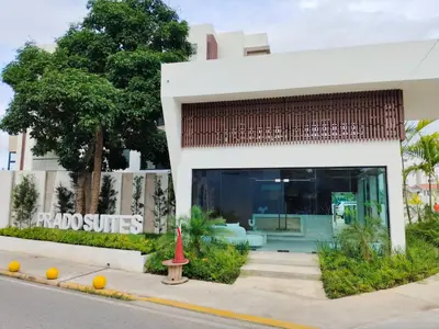 a red fire hydrant in front of a building at Prado Suites Las Terrenas in Las Terrenas