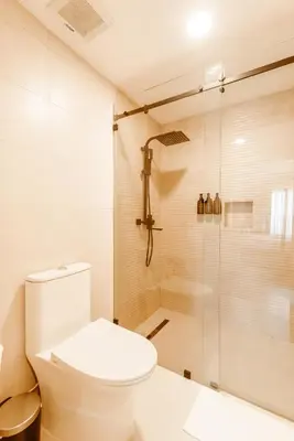 a bathroom with a toilet and a shower at Prado Suites Las Terrenas in Las Terrenas