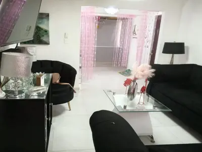 a living room with a black couch and a glass table at Prados de la Montana in Bartola