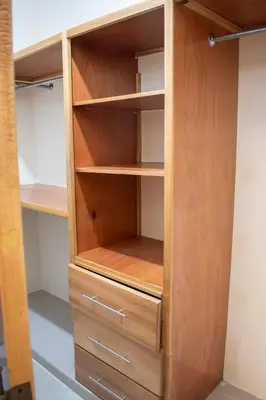 a wooden wardrobe with wooden shelves and drawers at Luxury Apartment in San Pedro de Macorís