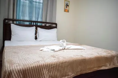 a bed with two white towels on it at Luxury Apartment in San Pedro de Macorís