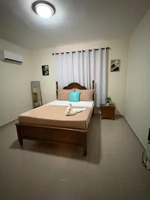 a bedroom with a large bed with a wooden frame at Luxury Apartment in San Pedro de Macorís
