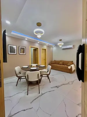 a living room with a table and chairs and a couch at Santana Building in San Pedro de Macorís