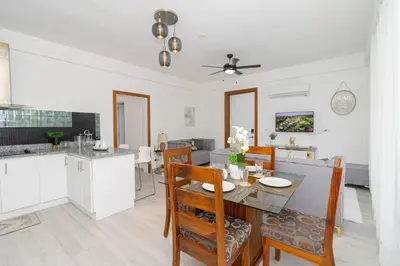 a kitchen and dining room with a table and chairs at Bright 2BR Apartment with Pool near Bayahibe Beach in San Rafael del Yuma