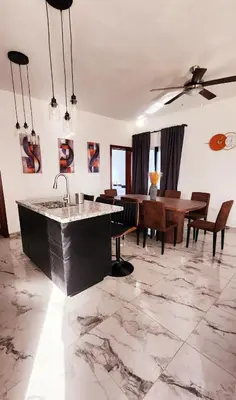 a living room with a sink and a table at Villa in SOV, close to Santa Fe in Sosúa