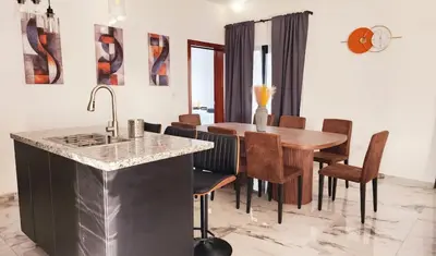 a kitchen and dining room with a table and chairs at Villa in SOV, close to Santa Fe in Sosúa