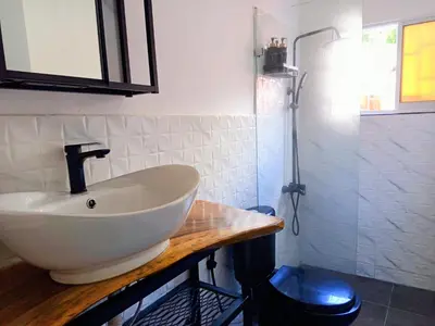 a bathroom with a white sink on a wooden counter at Italiana Hogares in Boca Chica