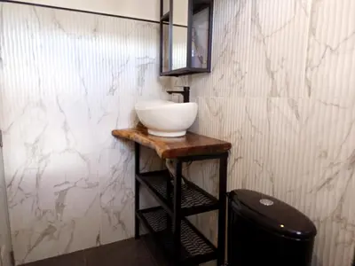 a bathroom with a white sink on a wooden table at Italiana Hogares in Boca Chica