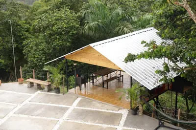 a house with a pitched roof and a bench at Casa Loma, Descansar en la Montaña, 30min STG in La Búcara