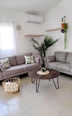 a living room with a couch and a table at Unique and quiet TROPICKÝ PRÁZDNINOVÝ DŮM in Punta Cana