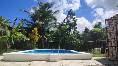 a pool in a yard with a fence and trees at Unique and quiet TROPICKÝ PRÁZDNINOVÝ DŮM in Punta Cana