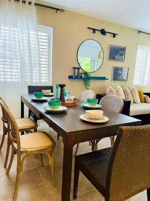 a dining table and chairs in a living room at Sole E Mare Beach House in Las Terrenas