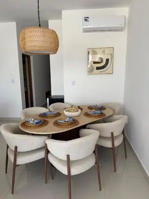 a dining room with a wooden table and chairs at Brand New Condo-Sunrise in Puerto Plata