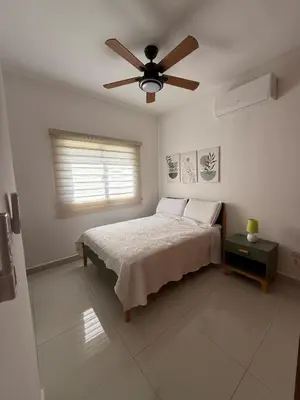 a bedroom with a bed and a ceiling fan at Brand New Condo-Sunrise in Puerto Plata