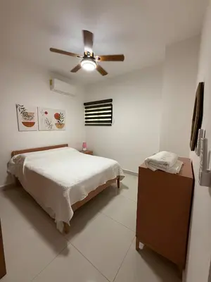 a bedroom with a bed and a ceiling fan at Brand New Condo-Sunrise in Puerto Plata
