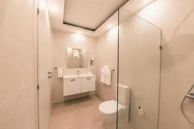 a bathroom with a toilet and a sink and a shower at Penthouse with jacuzzi in Lake View in Las Terrenas