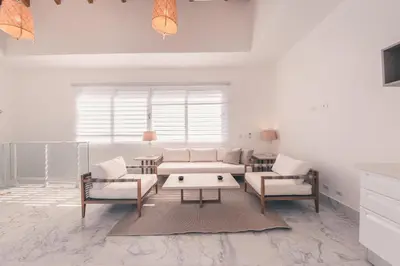 a living room with a couch and two chairs at Penthouse with jacuzzi in Lake View in Las Terrenas