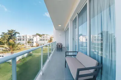 a balcony with a bench and views of the city at Penthouse with jacuzzi in Lake View in Las Terrenas