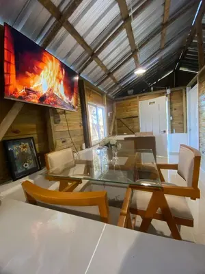 a living room with a table and a tv at La casa de jasinta in San Felipe de Puerto Plata