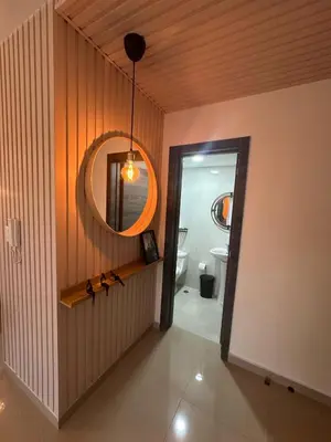 a hallway with a bathroom with a mirror and a sink at Urban oasis,3 beds, Elevator, Near the airport in Juan López