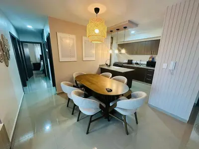 a dining room with a wooden table and chairs at Urban oasis,3 beds, Elevator, Near the airport in Juan López