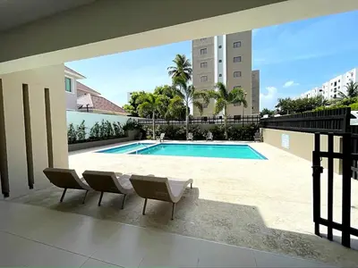 a view of a swimming pool in a building at Luxury Apartment- PRIVATE Patio & BBQ- Near Airport in Santiago de los Caballeros