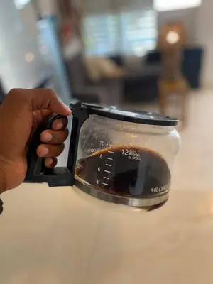a persons hand holding a cup of coffee at Bed-Breakfast lunch Tropical Private-room in Santa Bárbara de Samaná